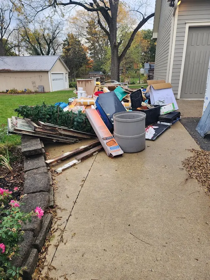 Dumpster being loaded with debris for 12 Yard Dumpster Rental in Tyler